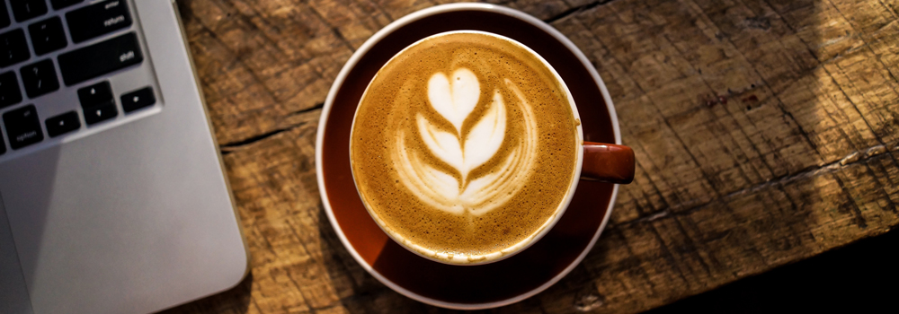 A notebook next to a cup of coffee suggesting that good services are provided.